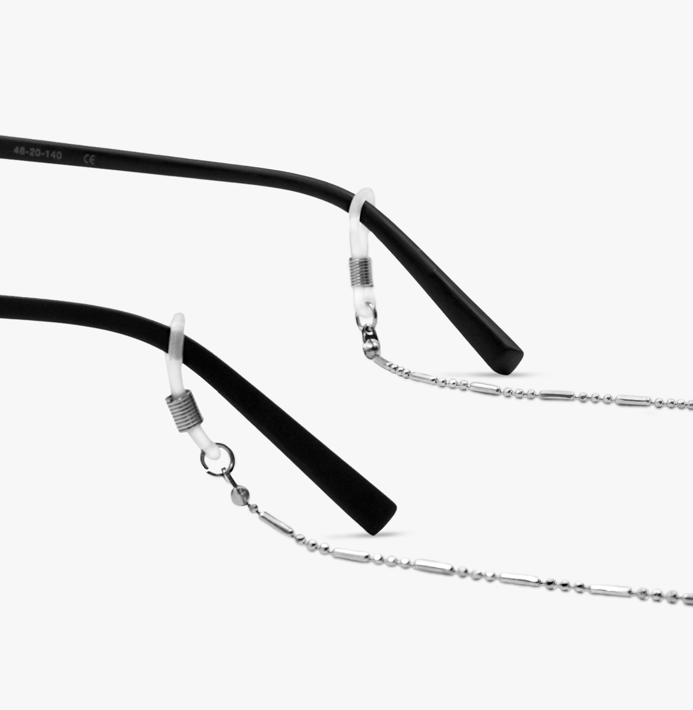 Silver cord attached to black eyeglass temples