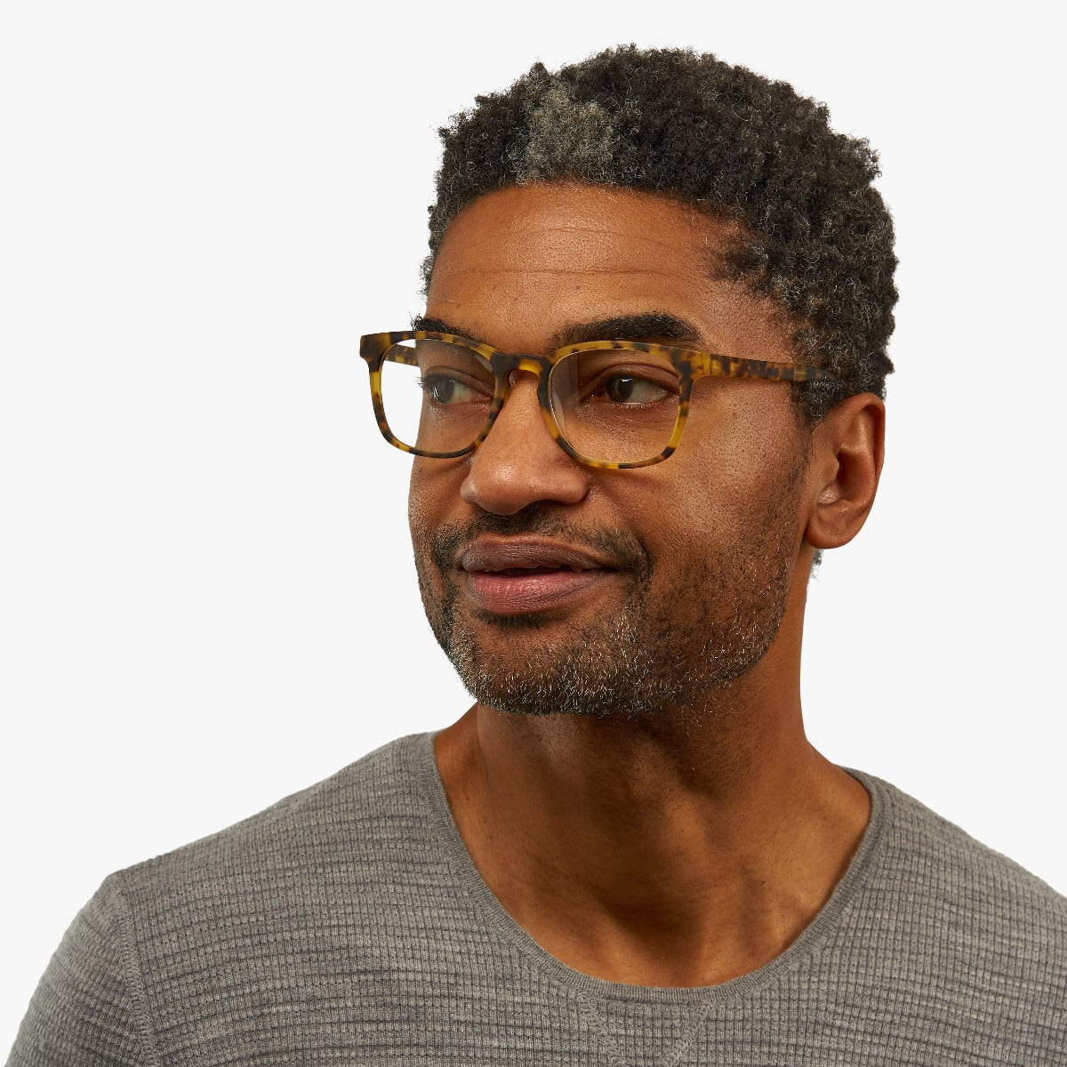 Person wearing tortoiseshell rectangular reading glasses