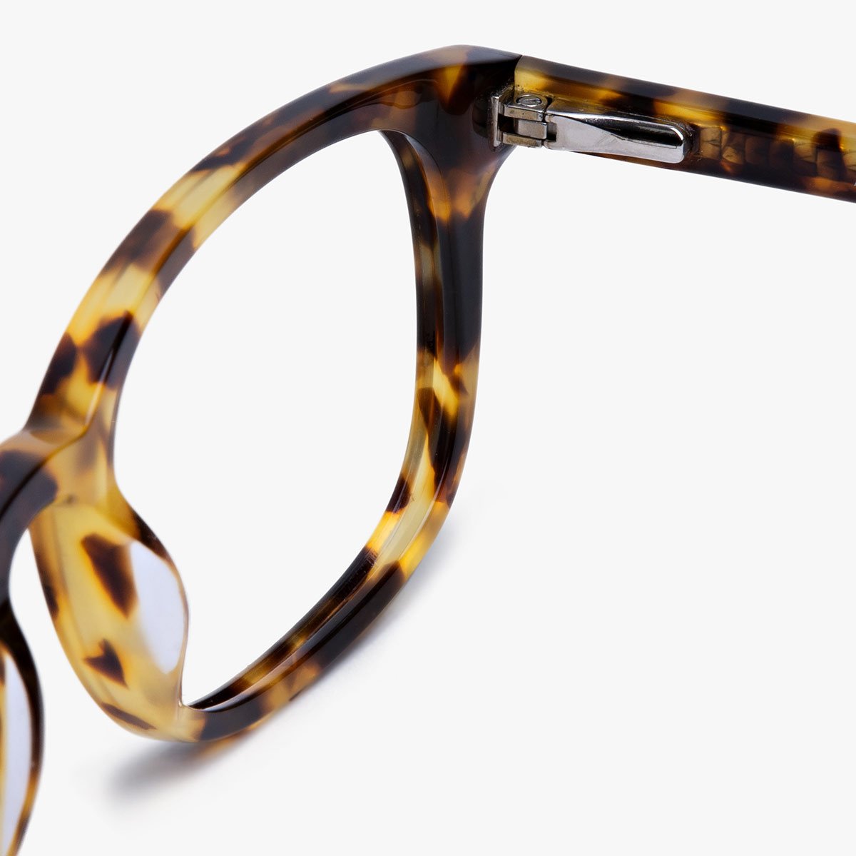 Tortoiseshell eyeglasses frame close-up with metal hinge detail