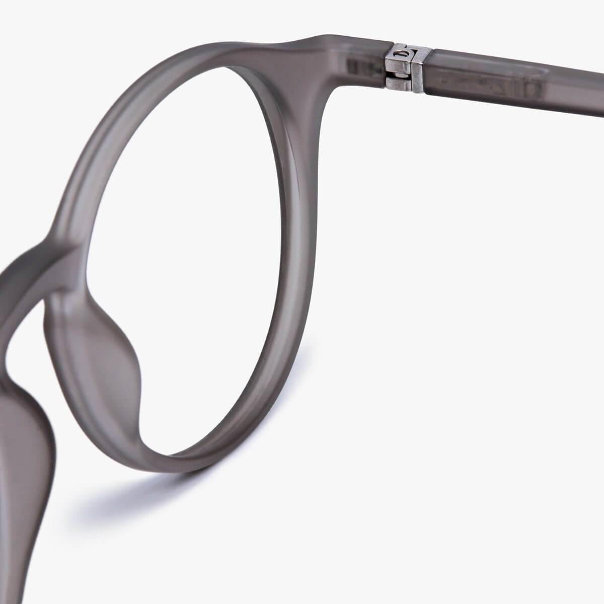 Close-up of grey reading glasses frame with silver hinge detail