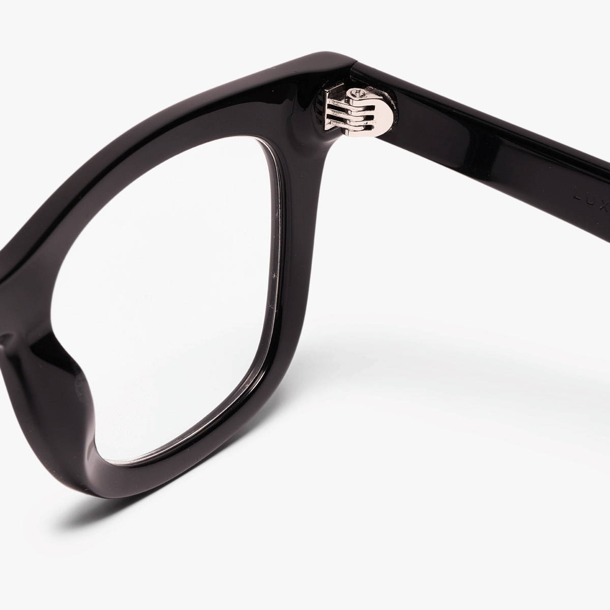 Close-up of black Samsø eyeglasses with metallic hinge detail