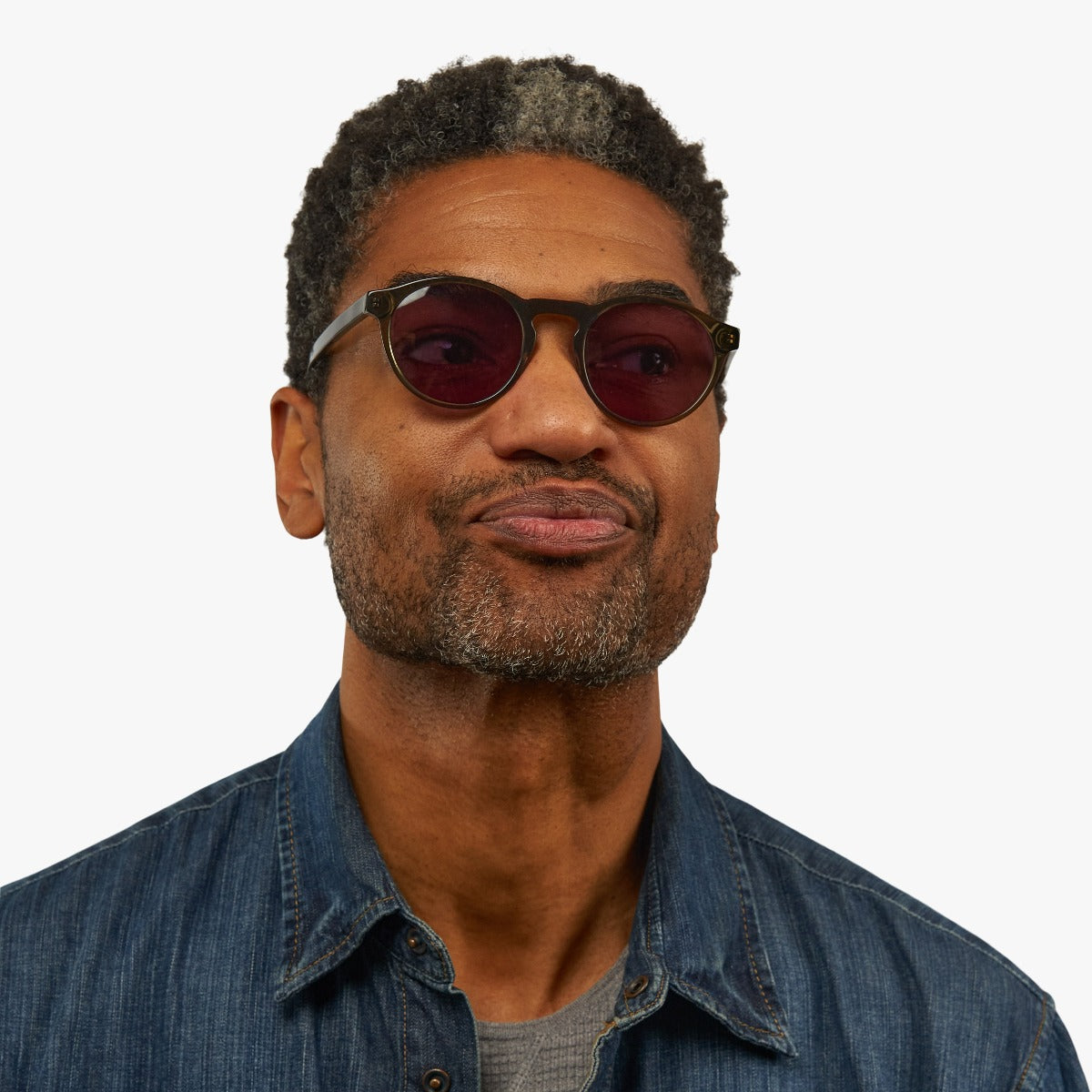 Person wearing Men's Trondheim Shiny Olive glasses with dark lenses
