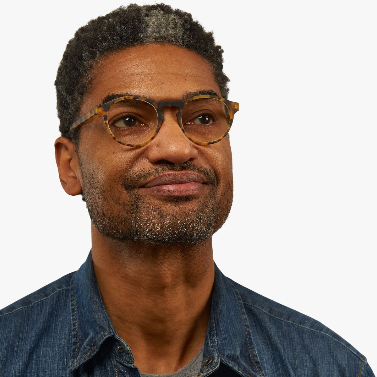 Person wearing tortoiseshell round glasses